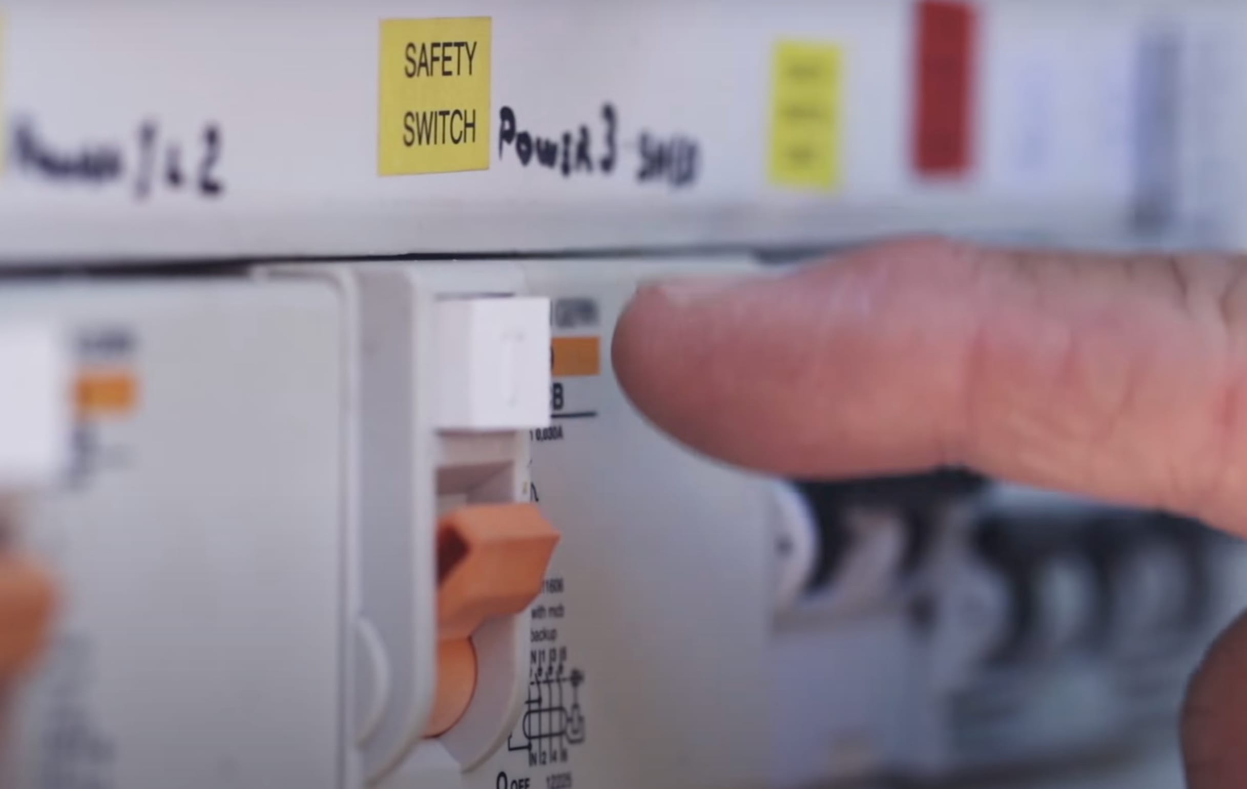 A finger pressing a safety switch
